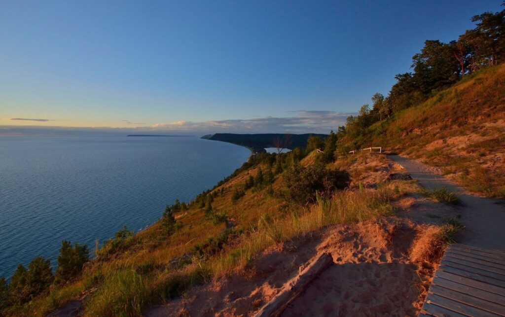Sleeping Bear Dunes bluffs dropping to Lake Michigan, seen from the Empire Bluff overlook at sunset