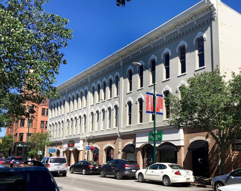 Row of restored brick and stone storefronts along Front Street downtown on a summer day