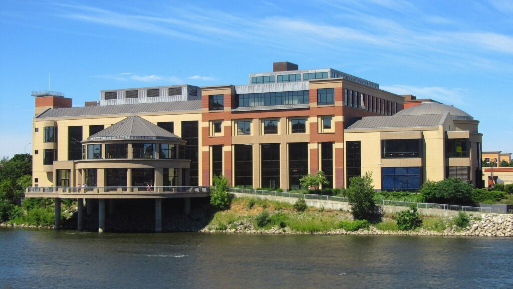 Grand Rapids Public Museum, a long building with a round glass pavilion on the bank of the Grand River