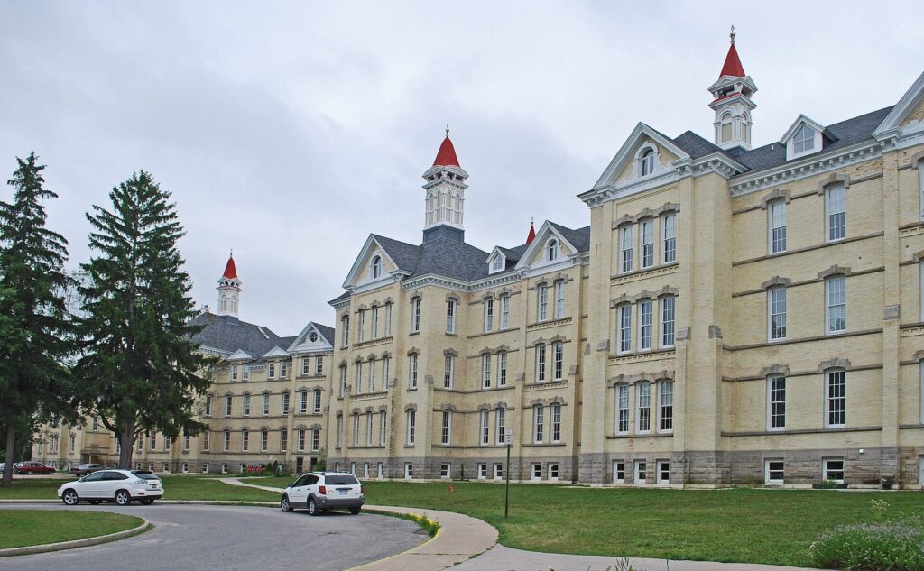Yellow-brick Victorian buildings with red-roofed cupolas at the Grand Traverse Commons