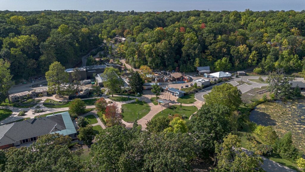 Aerial view of John Ball Zoo's paths, exhibits and ponds set in a wooded valley