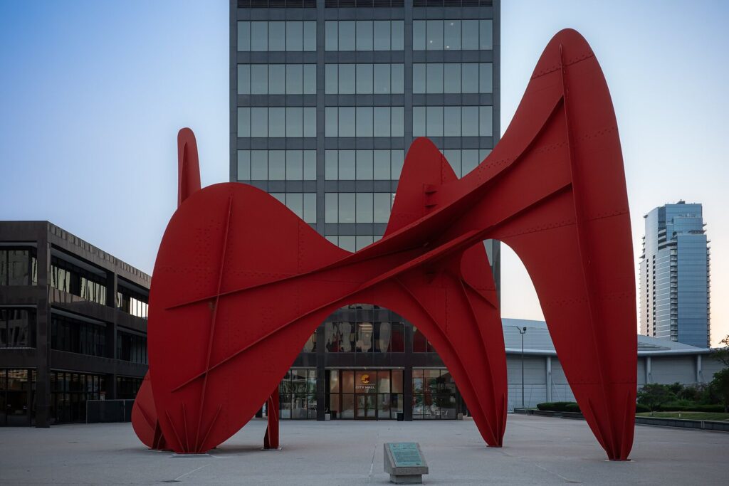 Alexander Calder's giant red steel sculpture La Grande Vitesse on a plaza in front of downtown office buildings