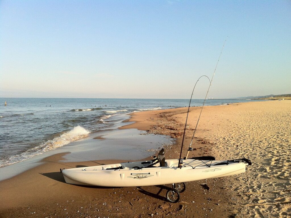 Wide sandy beach at Oval Beach on Lake Michigan with a fishing kayak pulled up at the waterline