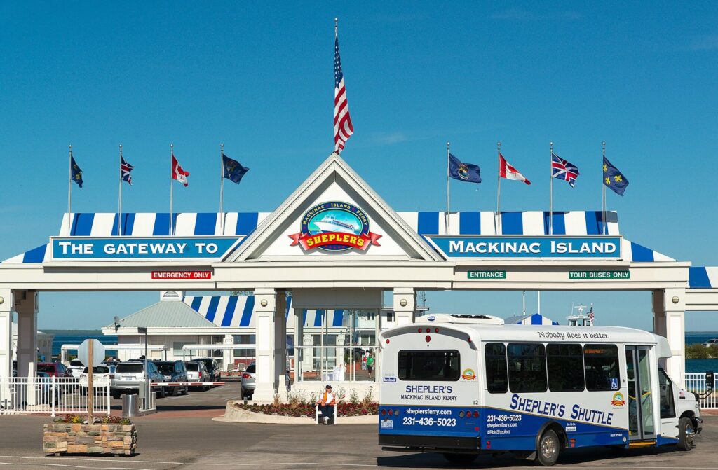 Shepler's ferry dock gateway in Mackinaw City with a shuttle bus parked in front